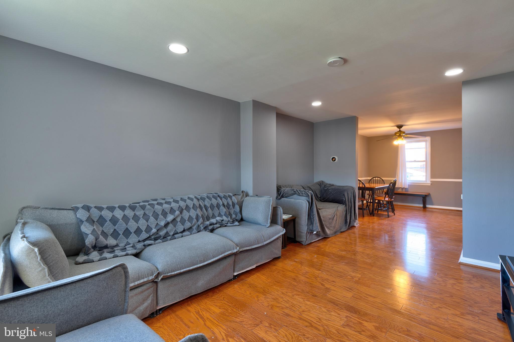 7817 St Fabian Lane Baltimore, MD 21222 - Photo 3 of 17 a living room with furniture and a wooden floor