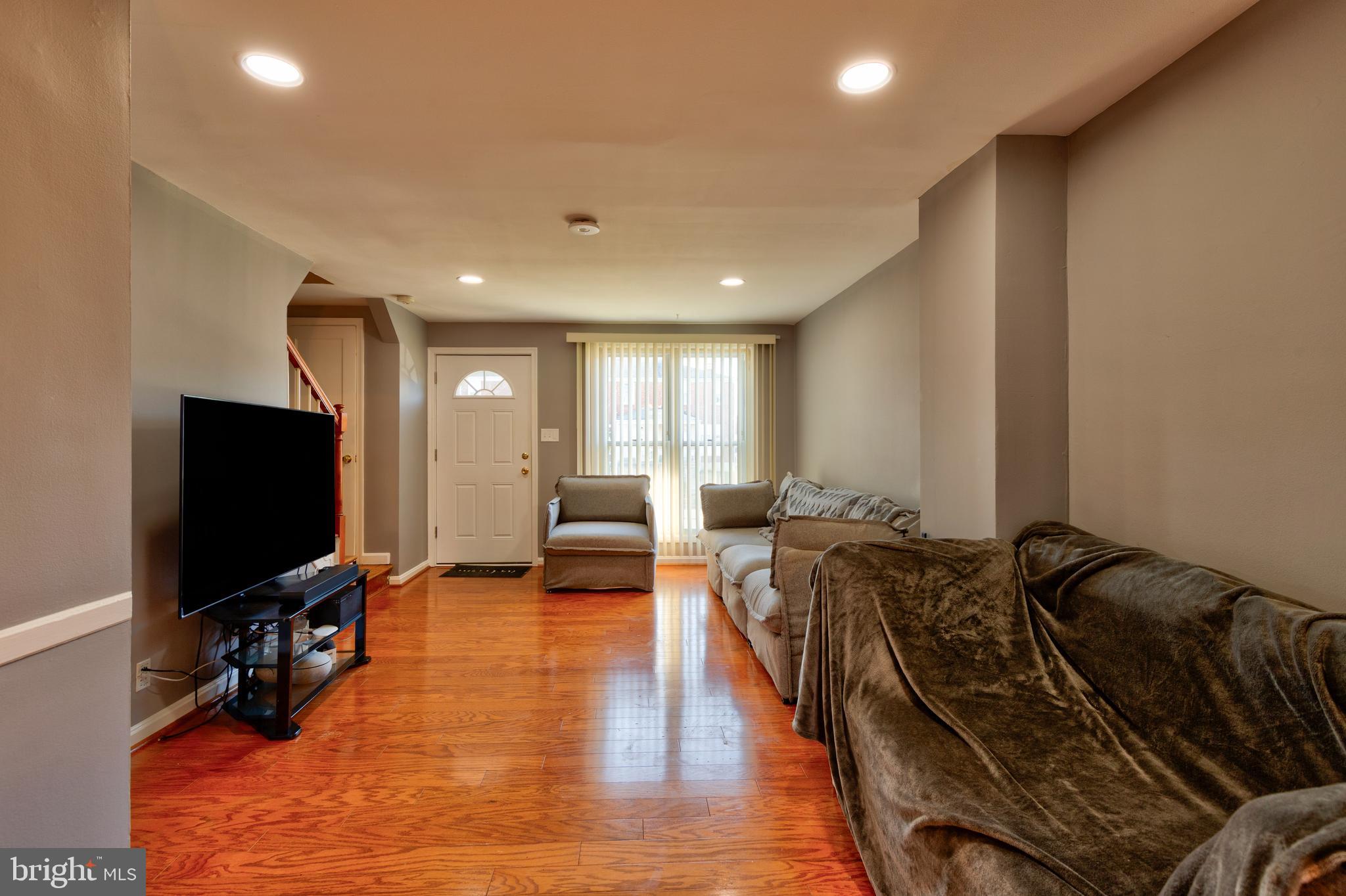 7817 St Fabian Lane Baltimore, MD 21222 - Photo 4 of 17 a living room with furniture and a flat screen tv