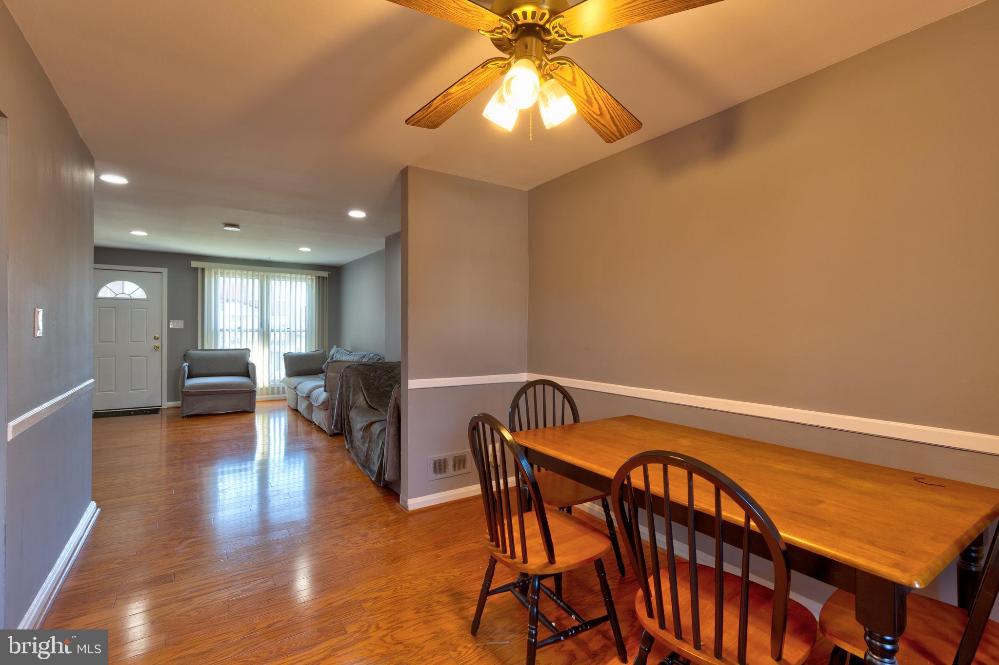 7817 St Fabian Lane Baltimore, MD 21222 - Photo 5 of 17 a view of a dining room with furniture and wooden floor