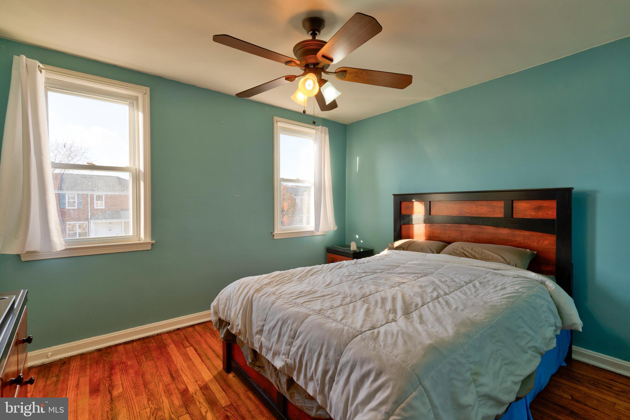 7817 St Fabian Lane Baltimore, MD 21222 - Photo 9 of 17 a bedroom with a bed and a chandelier