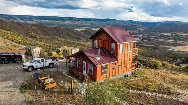 an aerial view of a houses with a ocean view