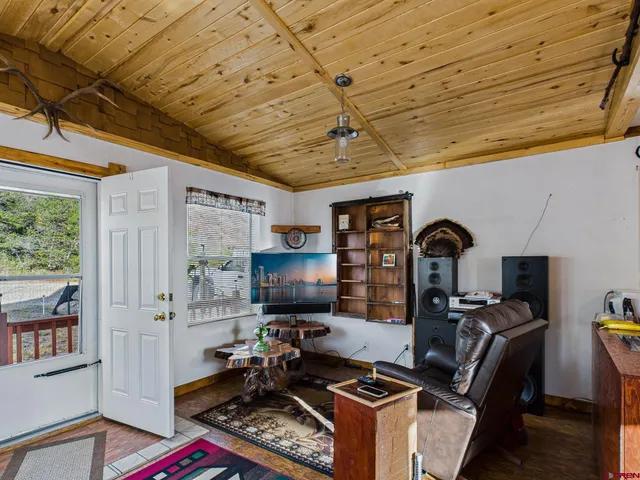 a bedroom with furniture and flat screen tv