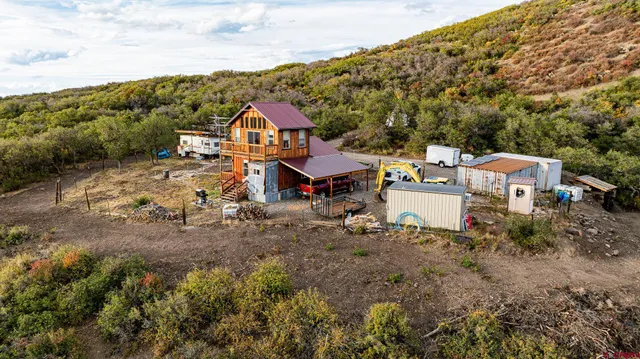 a view of a house with a yard and sitting area