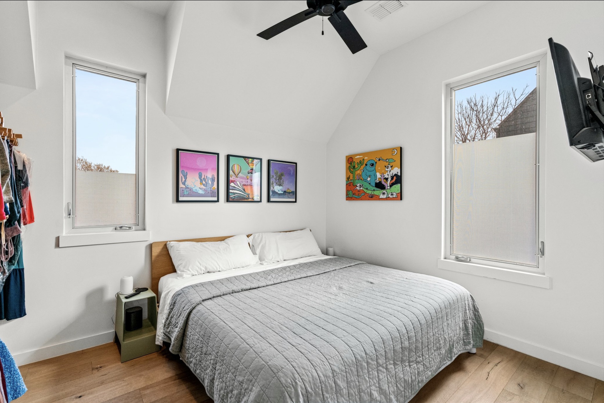 1608 Ravey Street, Unit B Austin, TX 78704 - Photo 15 of 25 Bedroom featuring light wood-type flooring, multiple windows, ceiling fan, and vaulted ceiling