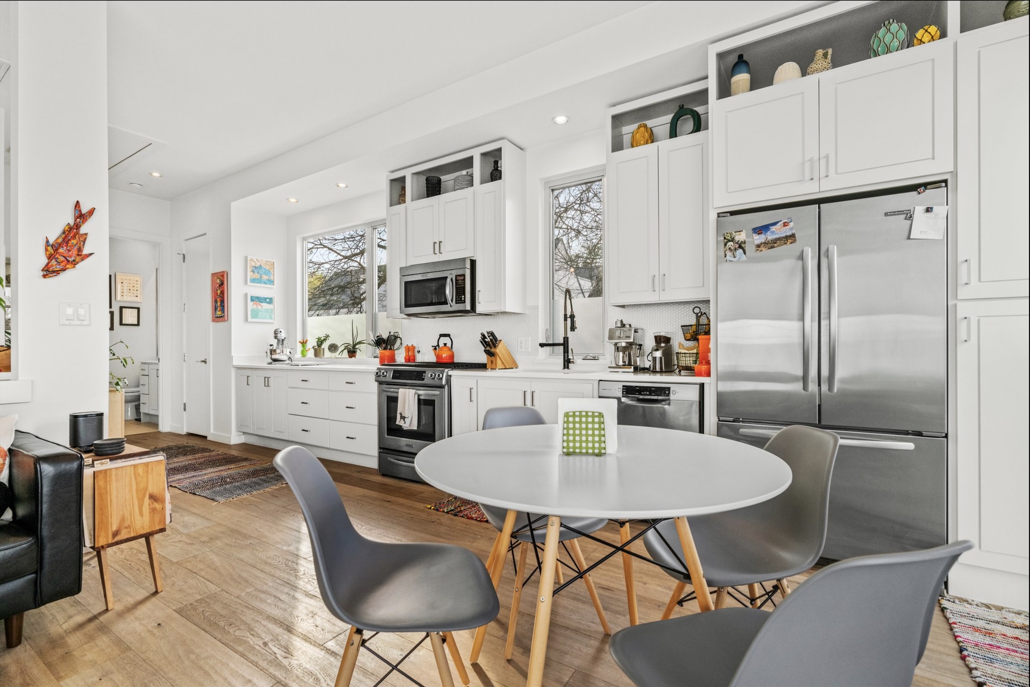 1608 Ravey Street, Unit B Austin, TX 78704 - Photo 20 of 25 Kitchen with white cabinetry, stainless steel appliances, light wood-style flooring, light countertops, and recessed lighting