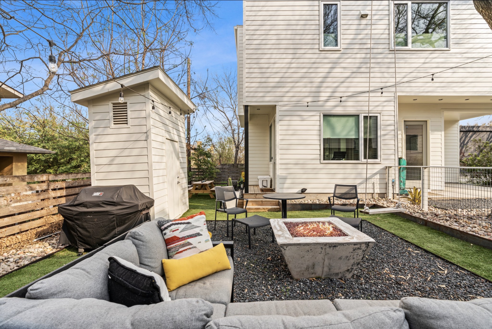 1608 Ravey Street, Unit B Austin, TX 78704 - Photo 8 of 25 Back of property featuring a patio area, a fire pit, and a fenced backyard