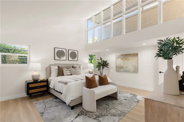 a bedroom with a bed a bookshelf and a couch