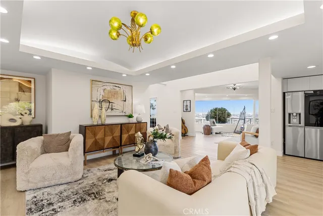 a living room with furniture and kitchen view