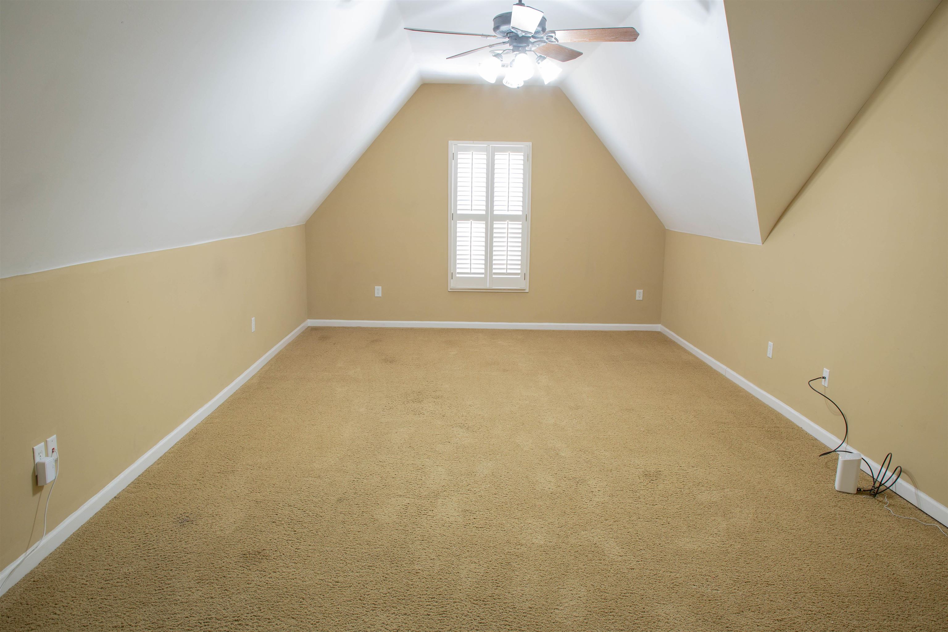4868 Rainy Pass Road Collierville, TN 38017 - Photo 16 of 20 an empty room with windows and chandelier fan