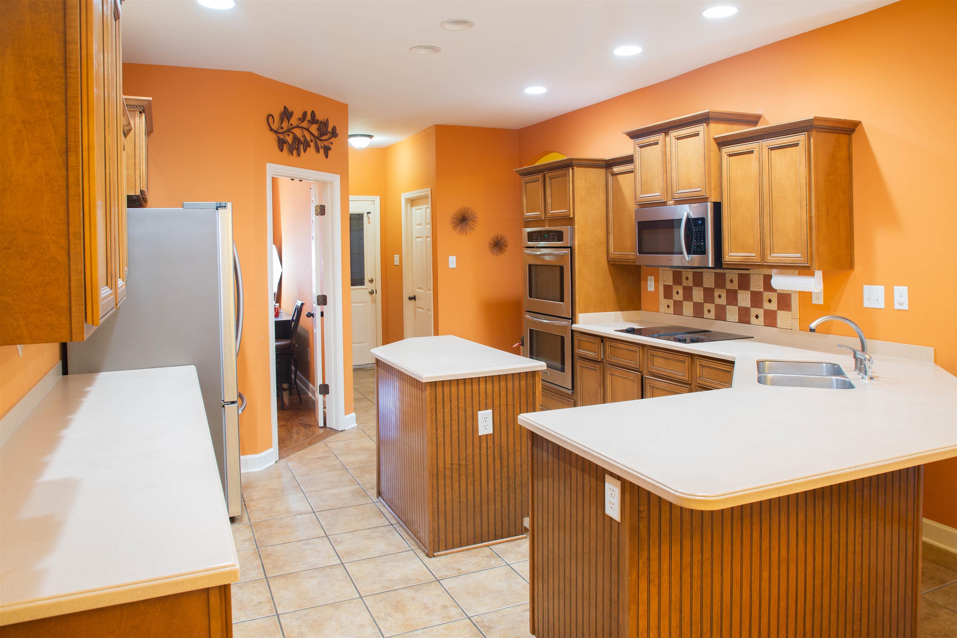 4868 Rainy Pass Road Collierville, TN 38017 - Photo 8 of 20 a kitchen with a sink a refrigerator and a stove