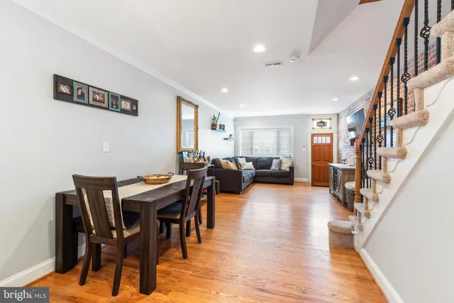 a living room with lots of furniture and a wooden floor