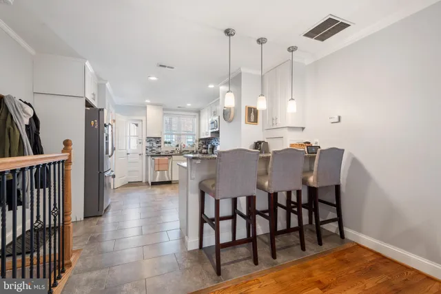 a view of kitchen with cabinets table and chairs