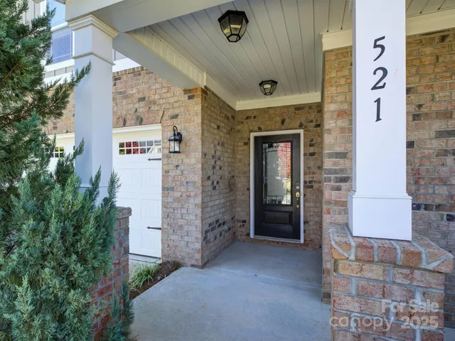 a living room with furniture kitchen view and a fireplace