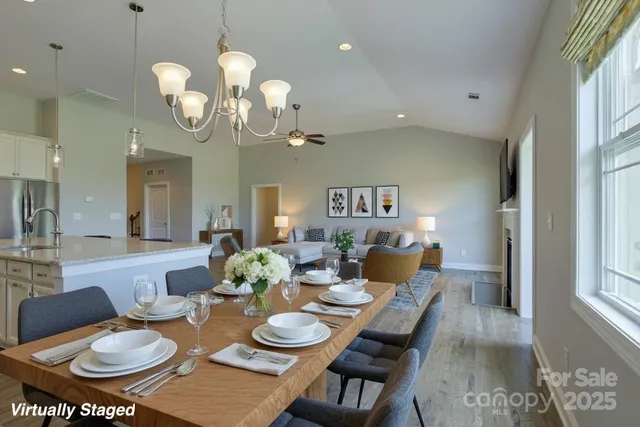 a kitchen with granite countertop a table chairs microwave and cabinets