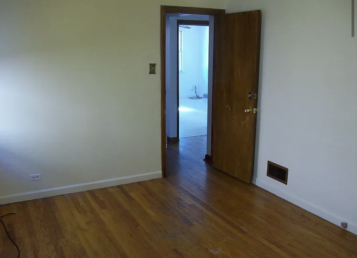 2433 Keystone Avenue North Riverside, IL 60546 - Photo 5 of 13 a view of an empty room with wooden floor and a window