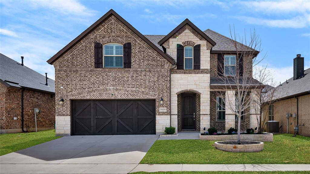 9609 Mountain Laurel Trail Fort Worth, TX 76036 - Photo 1 of 1 French provincial home featuring stone siding, driveway, central AC unit, brick siding, and a garage