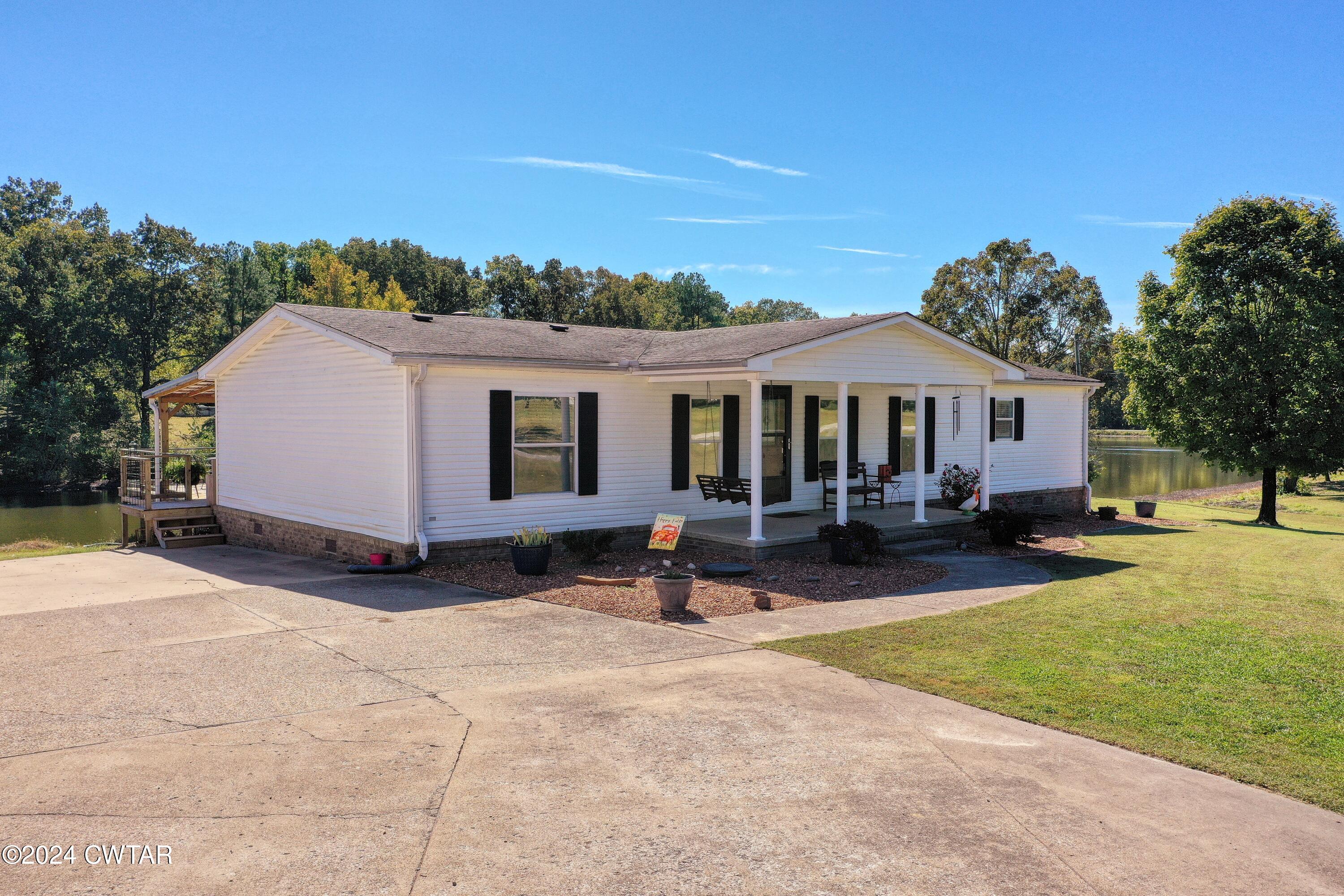 194 Mccadams Road McKenzie, TN 38201 - Photo 3 of 43 a view of a house with a yard and sitting area