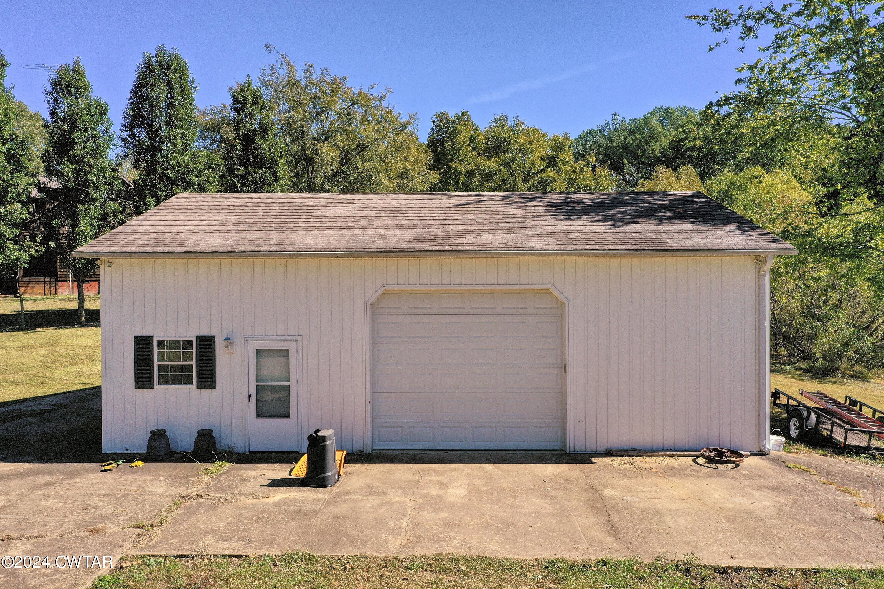 194 Mccadams Road McKenzie, TN 38201 - Photo 42 of 43 a backyard of a house with yard and trees in the back