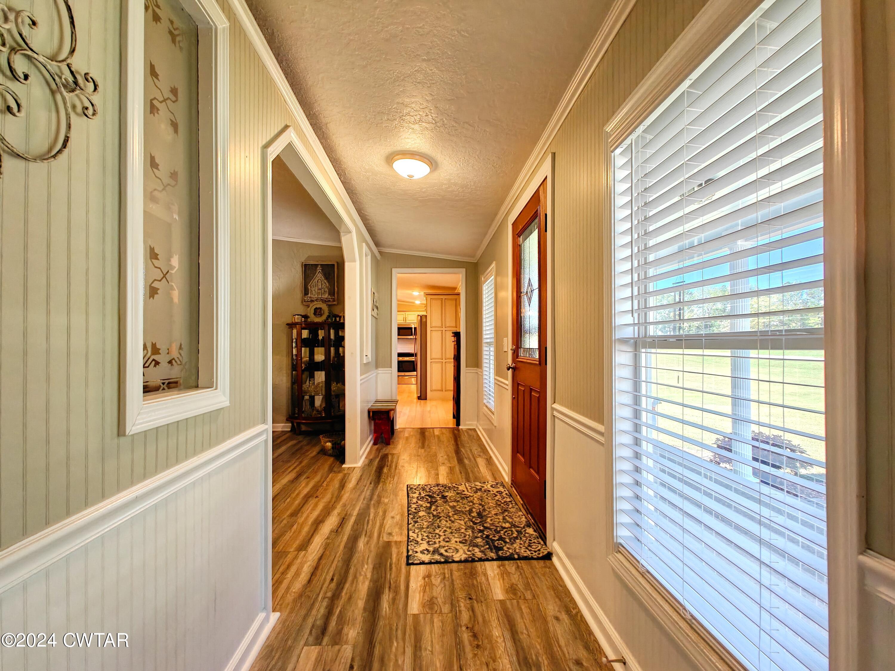 194 Mccadams Road McKenzie, TN 38201 - Photo 5 of 43 a view of a hallway with wooden floor and staircase
