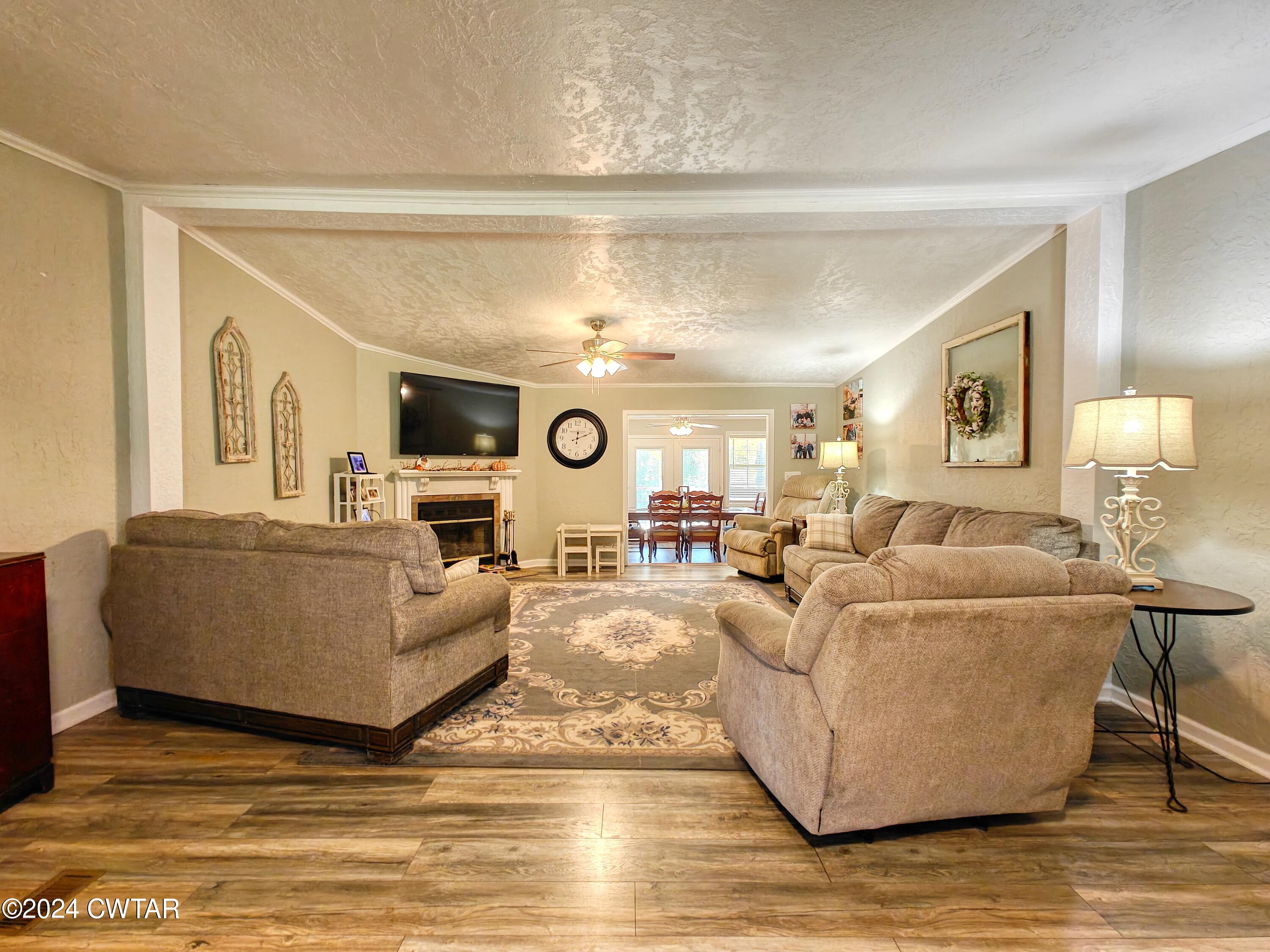 194 Mccadams Road McKenzie, TN 38201 - Photo 7 of 43 a living room with furniture and a chandelier