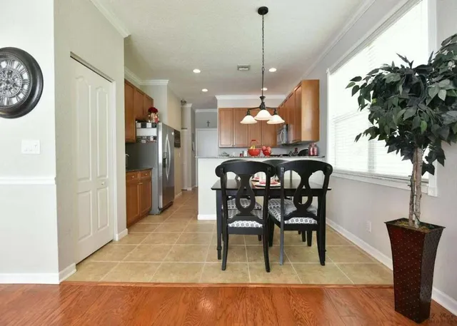 a view of a dining room with furniture window and wooden floor