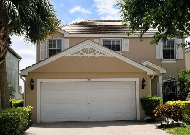 a house with palm tree in front of it