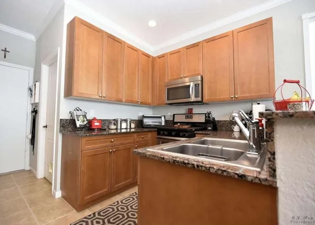 a kitchen with a sink a stove and cabinets