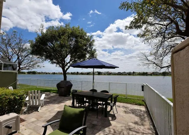 a view of a chairs and table in the patio with a fire pit