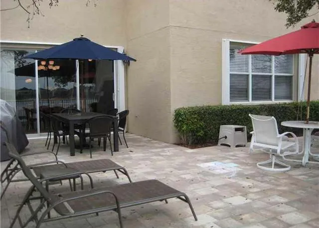 a view of a patio with a table and chairs