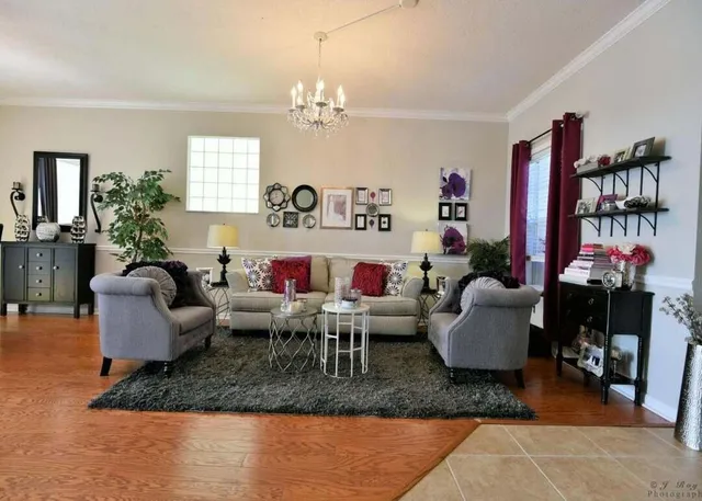 a living room with fireplace furniture and a chandelier