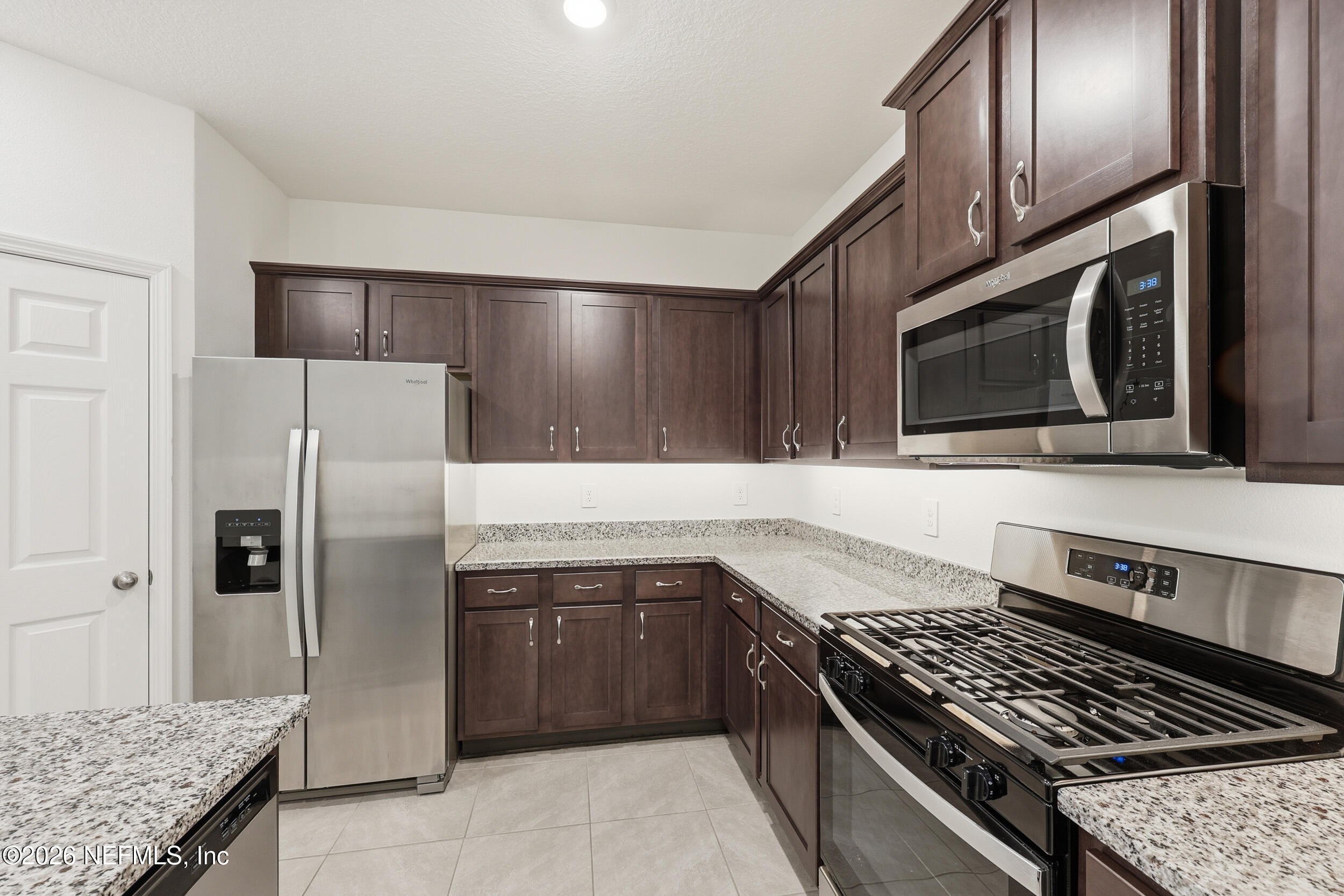 70 Barley Street St. Augustine, FL 32092 - Photo 11 of 40 a kitchen with stainless steel appliances granite countertop a stove a sink and a microwave