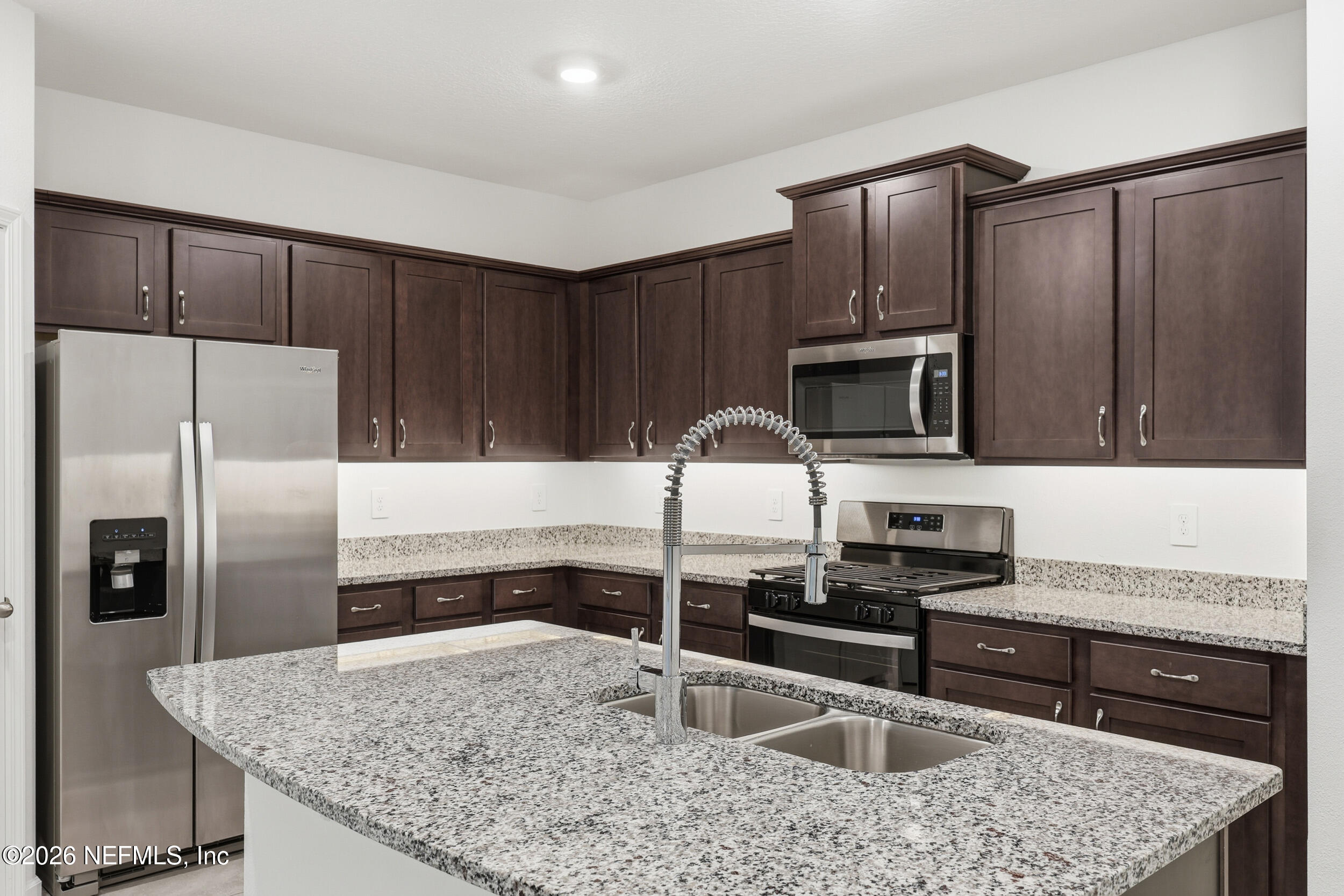 70 Barley Street St. Augustine, FL 32092 - Photo 12 of 40 a kitchen with granite countertop a refrigerator and a sink