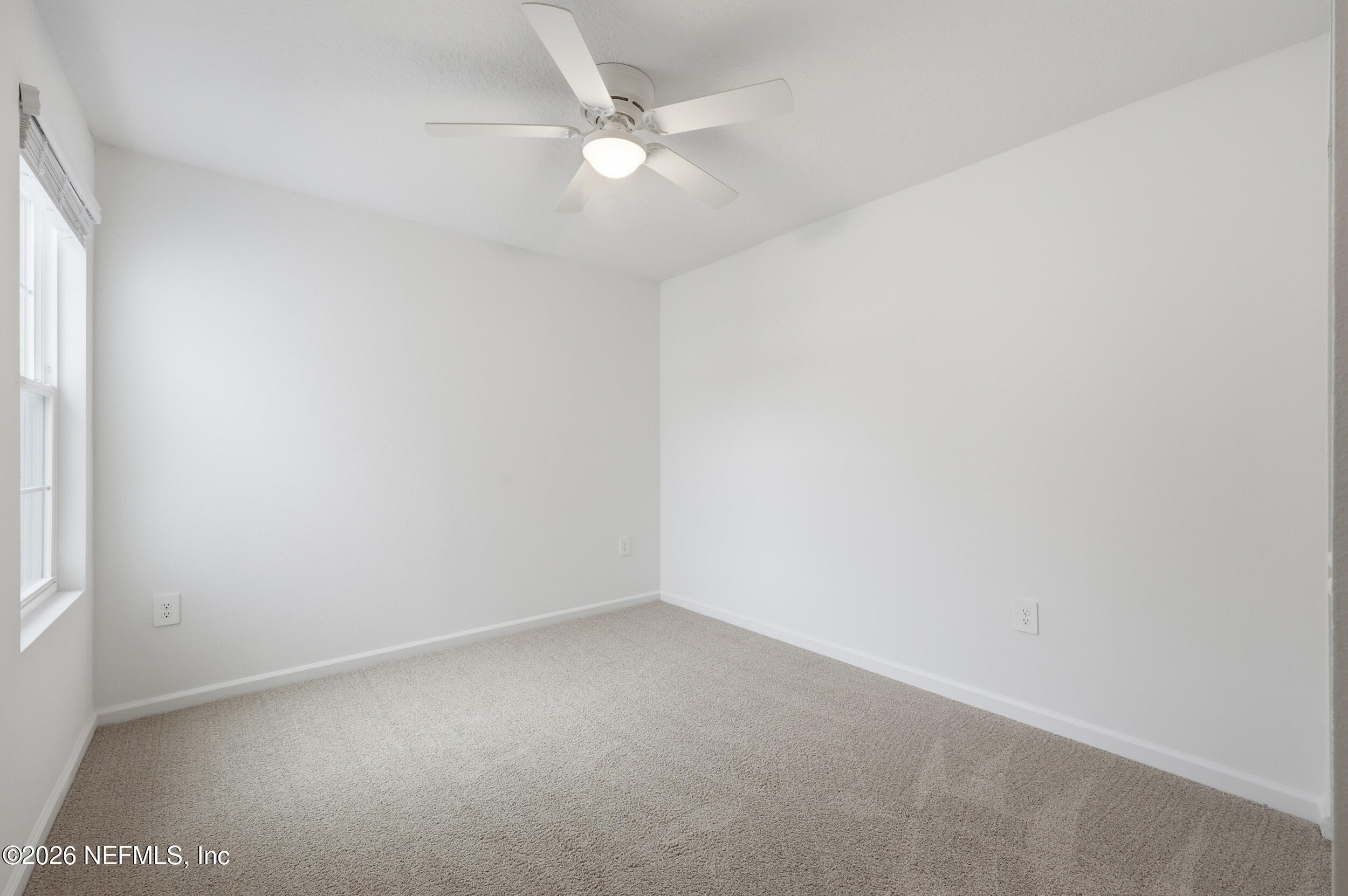 70 Barley Street St. Augustine, FL 32092 - Photo 25 of 40 an empty room with a window and a fan