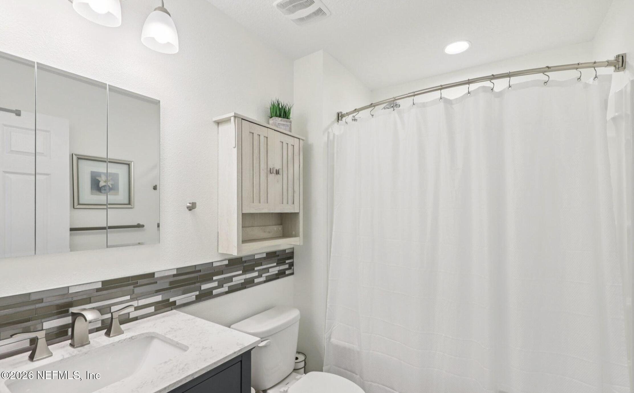 70 Barley Street St. Augustine, FL 32092 - Photo 27 of 40 a bathroom with a sink a toilet and shower