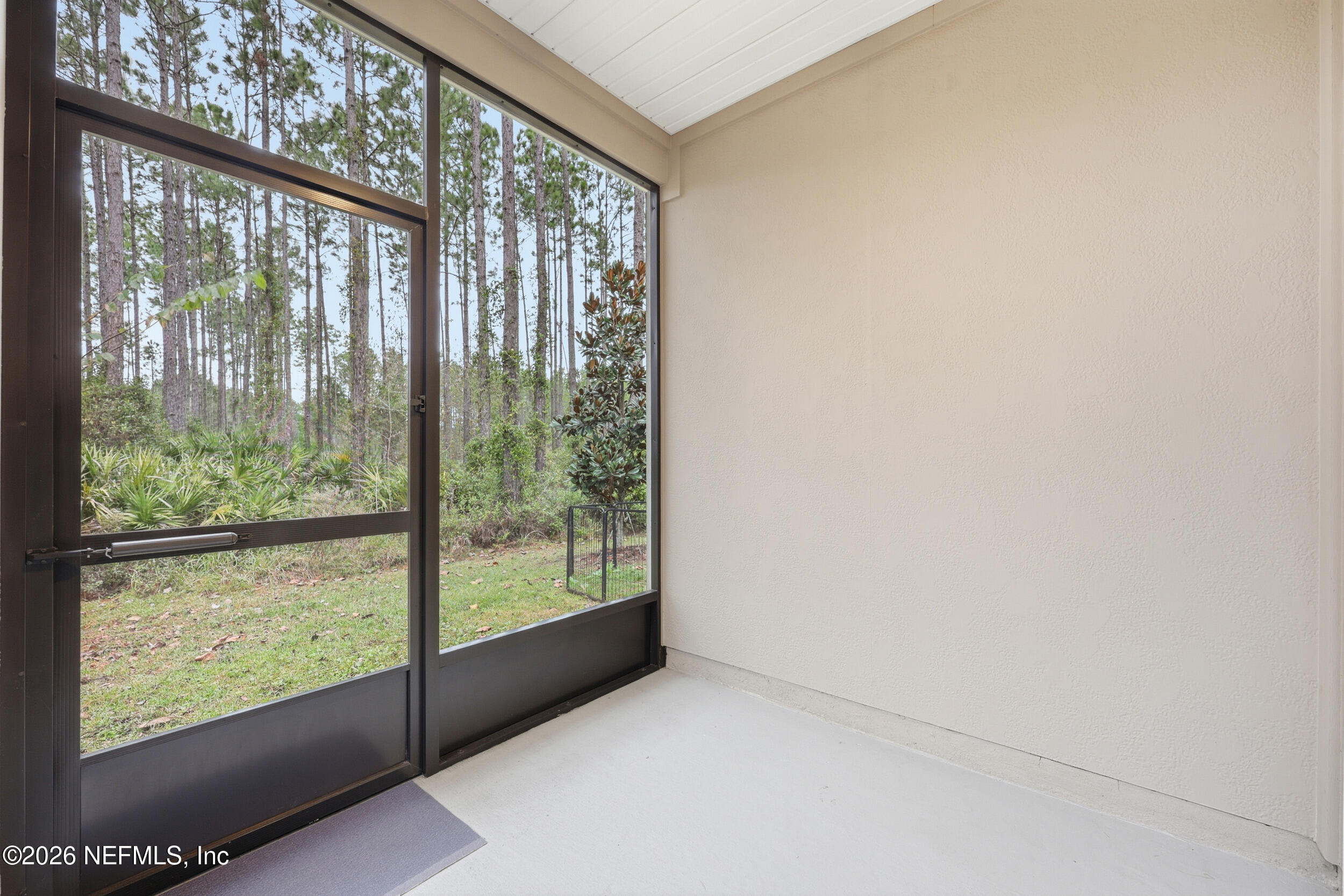 70 Barley Street St. Augustine, FL 32092 - Photo 32 of 40 an empty room with wooden floor and doors