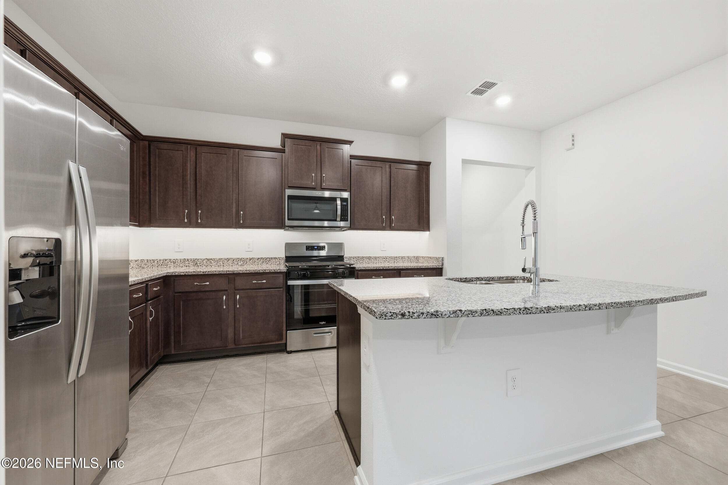 70 Barley Street St. Augustine, FL 32092 - Photo 7 of 40 a kitchen with stainless steel appliances granite countertop a sink stove and refrigerator