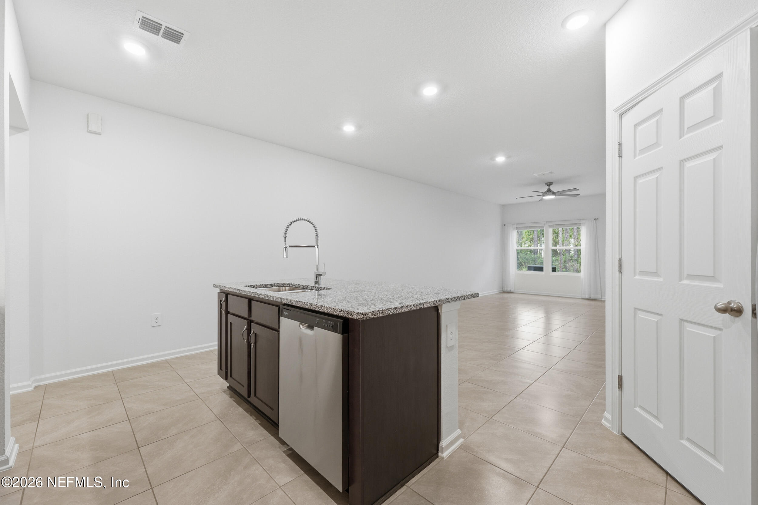 70 Barley Street St. Augustine, FL 32092 - Photo 8 of 40 a view of a kitchen with a sink and dishwasher a refrigerator with white cabinets