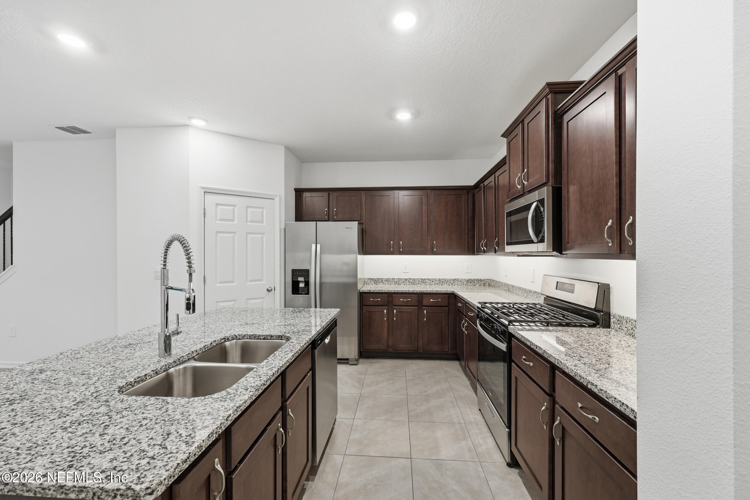 70 Barley Street St. Augustine, FL 32092 - Photo 9 of 40 a kitchen with stainless steel appliances granite countertop a sink stove and cabinets