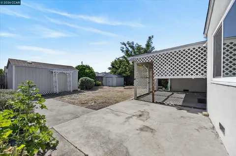 a view of a backyard with a sitting area and a garage