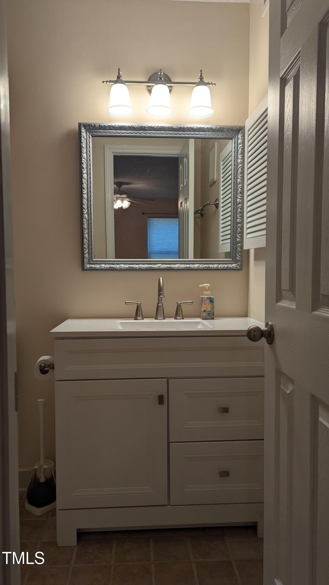 105 Broad Leaf Circle Raleigh, NC 27613 - Photo 11 of 19 a bathroom with a sink and a mirror