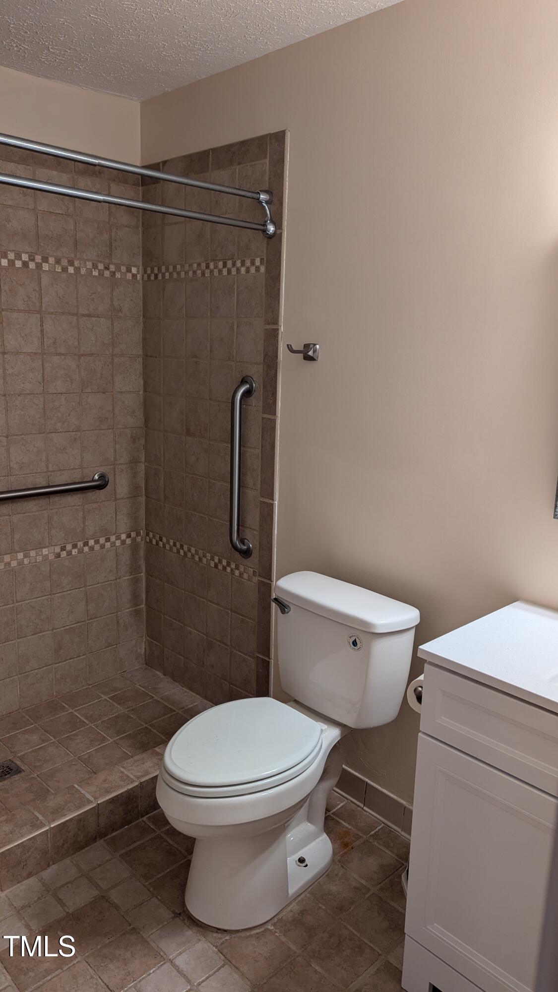 105 Broad Leaf Circle Raleigh, NC 27613 - Photo 12 of 19 a white toilet sitting next to a shower