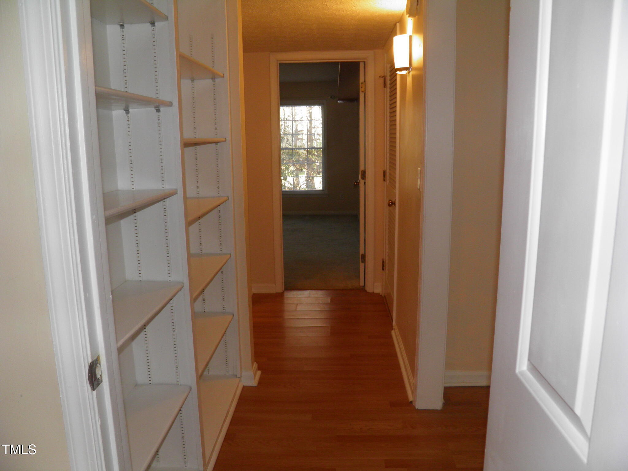 105 Broad Leaf Circle Raleigh, NC 27613 - Photo 13 of 19 a view of a hallway with wooden floor and staircase