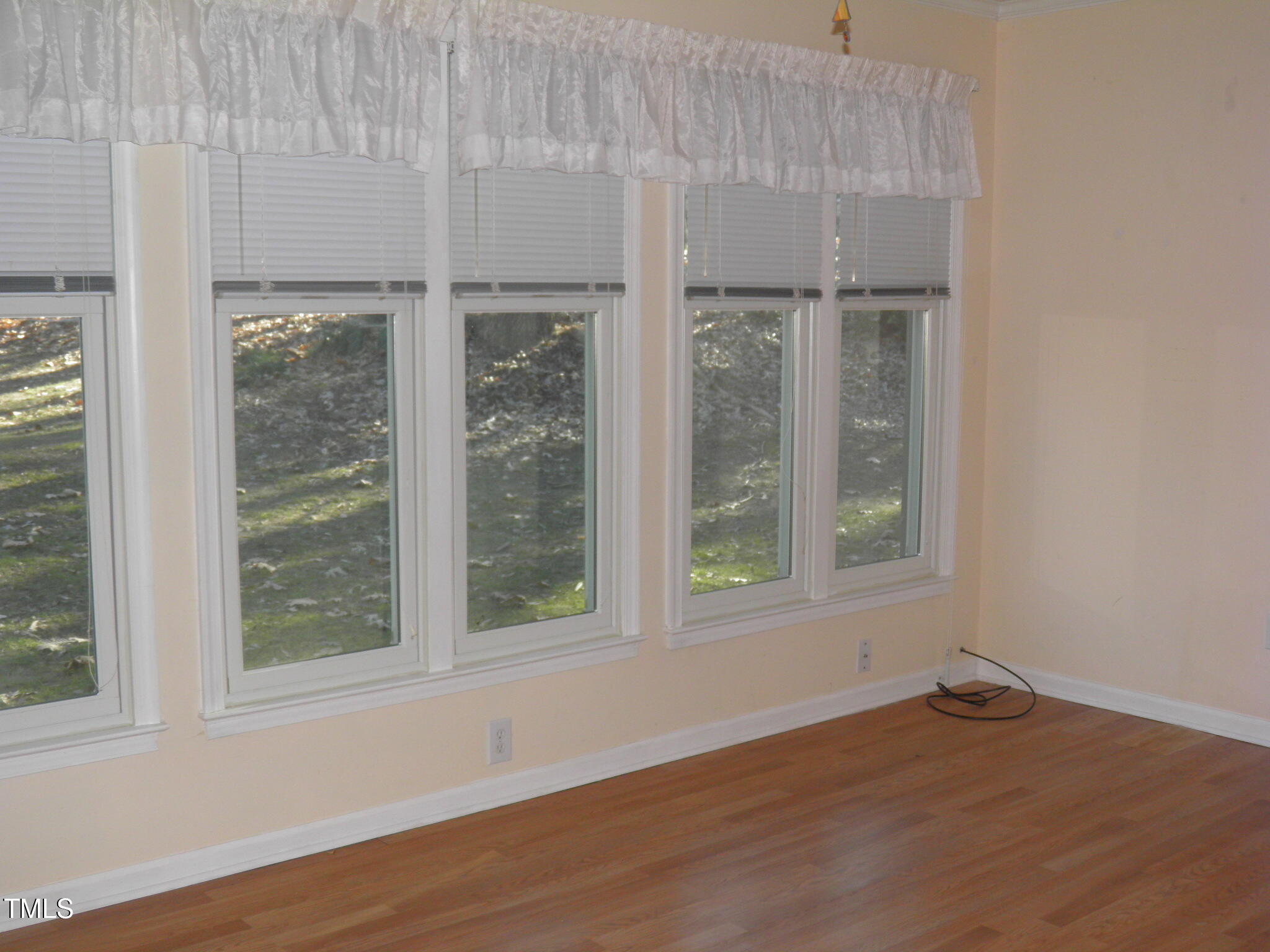 105 Broad Leaf Circle Raleigh, NC 27613 - Photo 16 of 19 a view of an empty room with wooden floor and a window