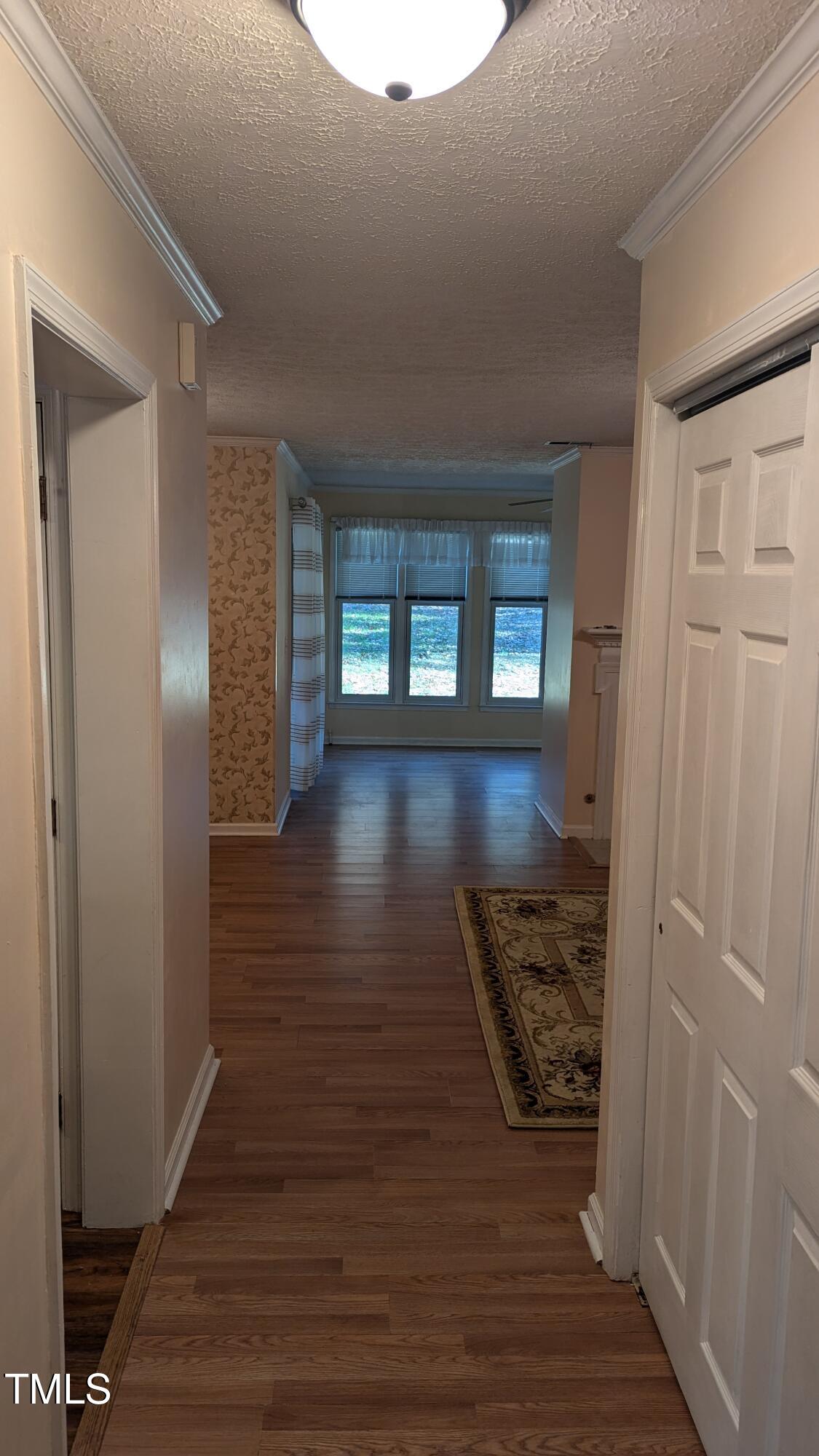 105 Broad Leaf Circle Raleigh, NC 27613 - Photo 4 of 19 a view of hallway with wooden floor and stairs