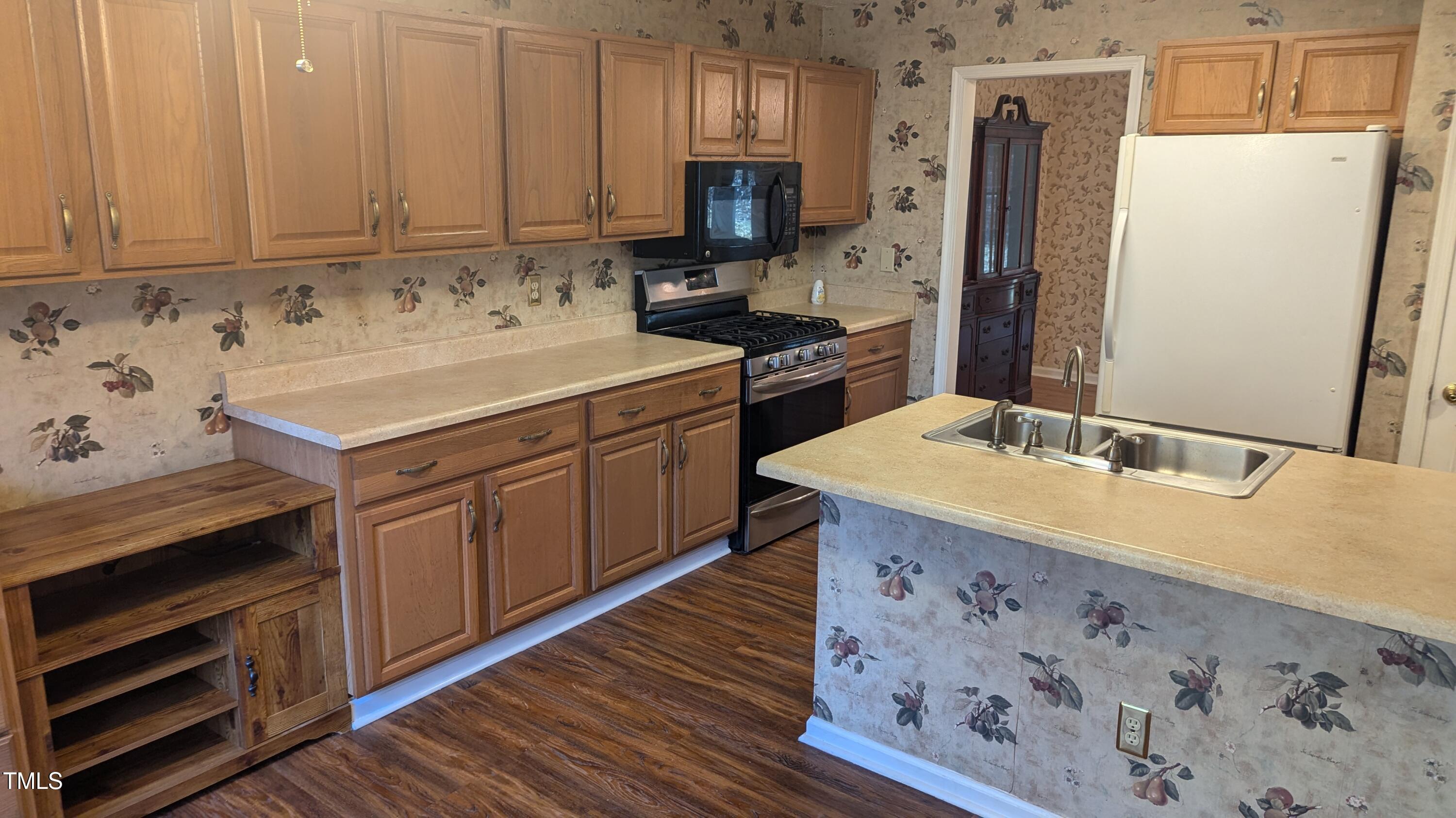 105 Broad Leaf Circle Raleigh, NC 27613 - Photo 5 of 19 a kitchen with a sink stove and refrigerator