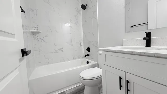 a bathroom with a sink a toilet and a bathtub