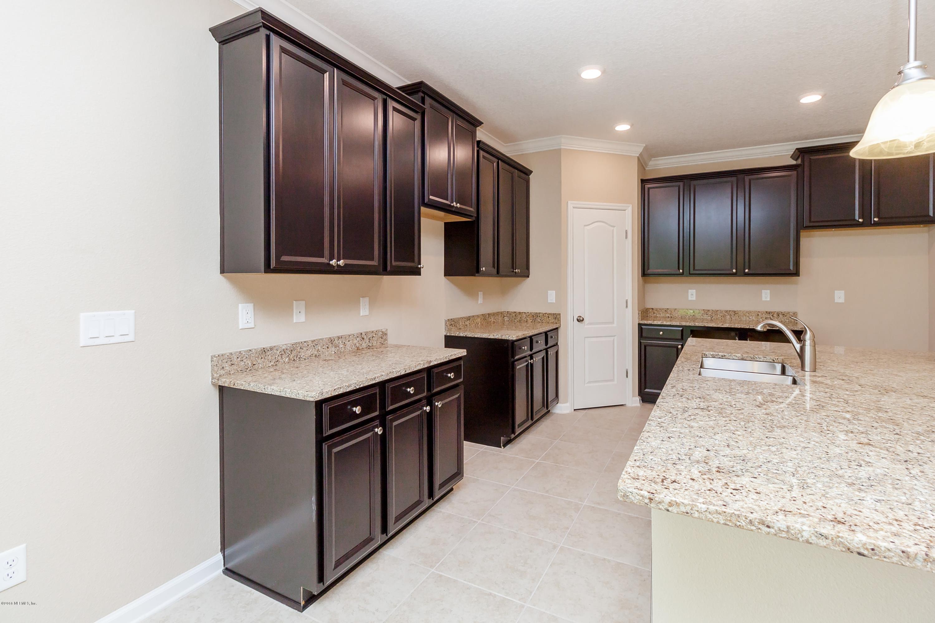 15714 Tisons Bluff Road Jacksonville, FL 32218 - Photo 11 of 44 a kitchen with stainless steel appliances granite countertop a stove sink and cabinets