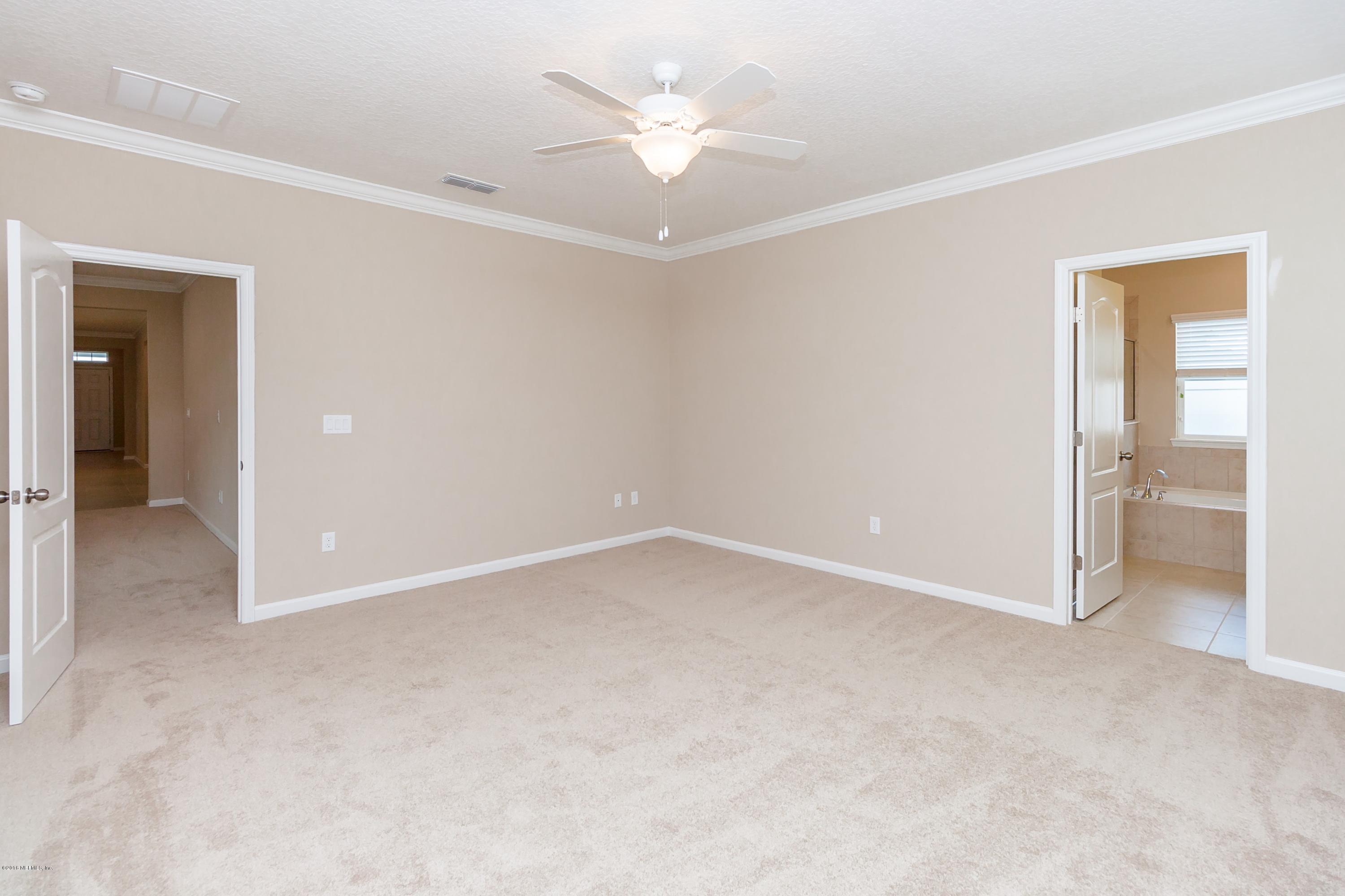 15714 Tisons Bluff Road Jacksonville, FL 32218 - Photo 27 of 44 an empty room with a ceiling fan and a window