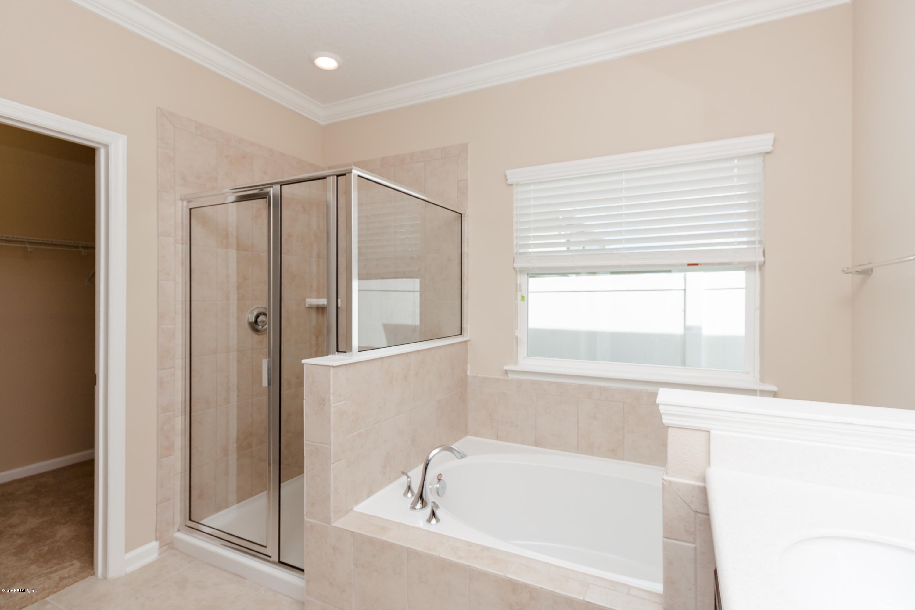 15714 Tisons Bluff Road Jacksonville, FL 32218 - Photo 31 of 44 a bathroom with a bathtub and a shower