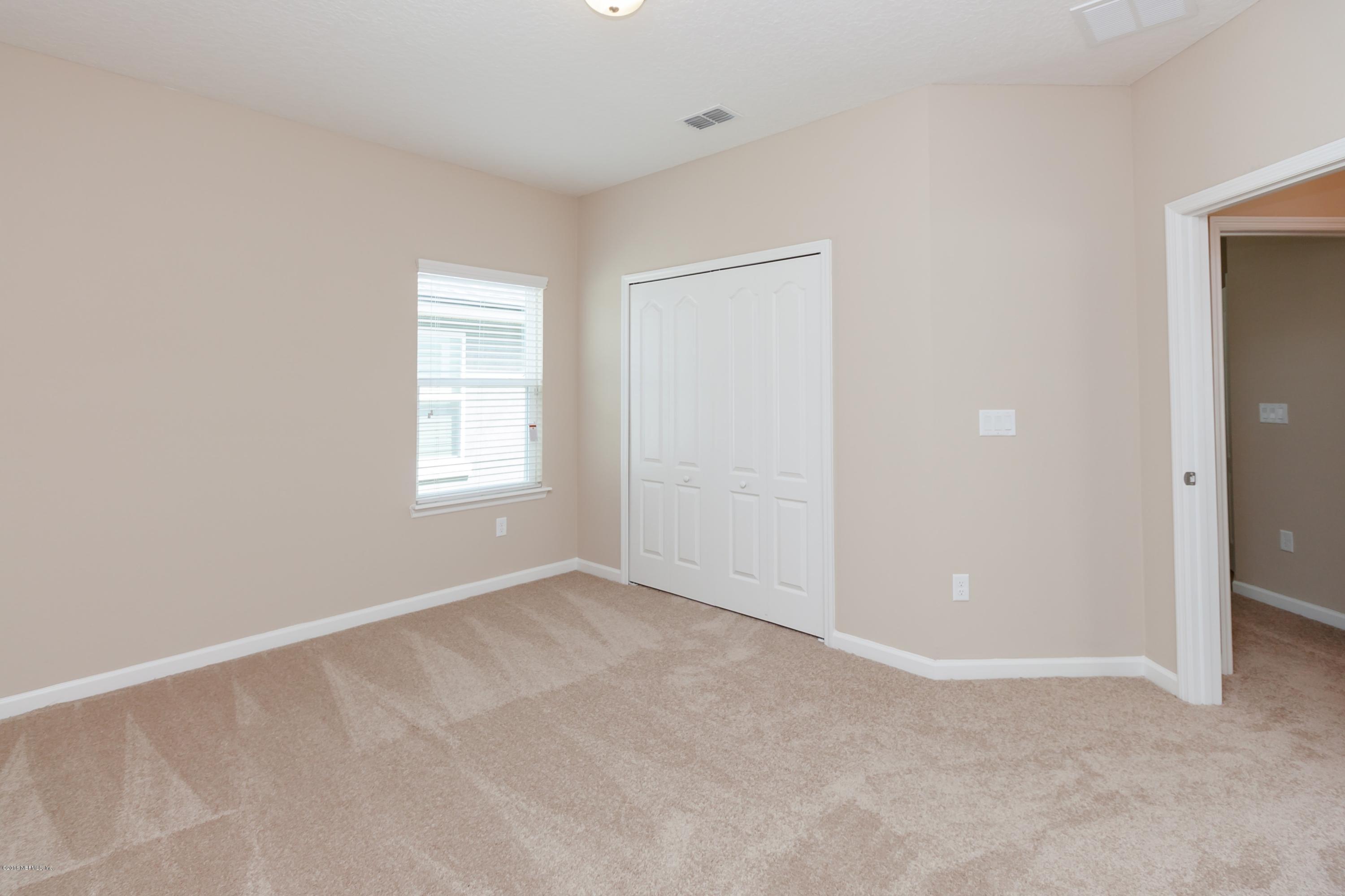 15714 Tisons Bluff Road Jacksonville, FL 32218 - Photo 33 of 44 an empty room with windows and closet
